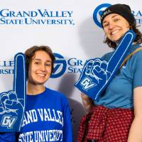 individuals smiling with blue grand valley shirt